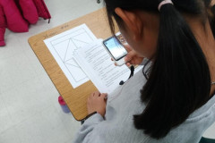 Yewon (native Korean speaker) using a Pocket Talk to translate reading work. 