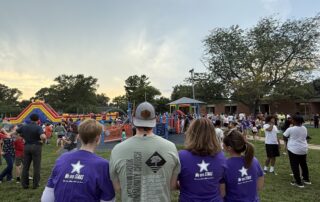 Kenwood and Meadowbrook staff surveying the back to school picnic together
